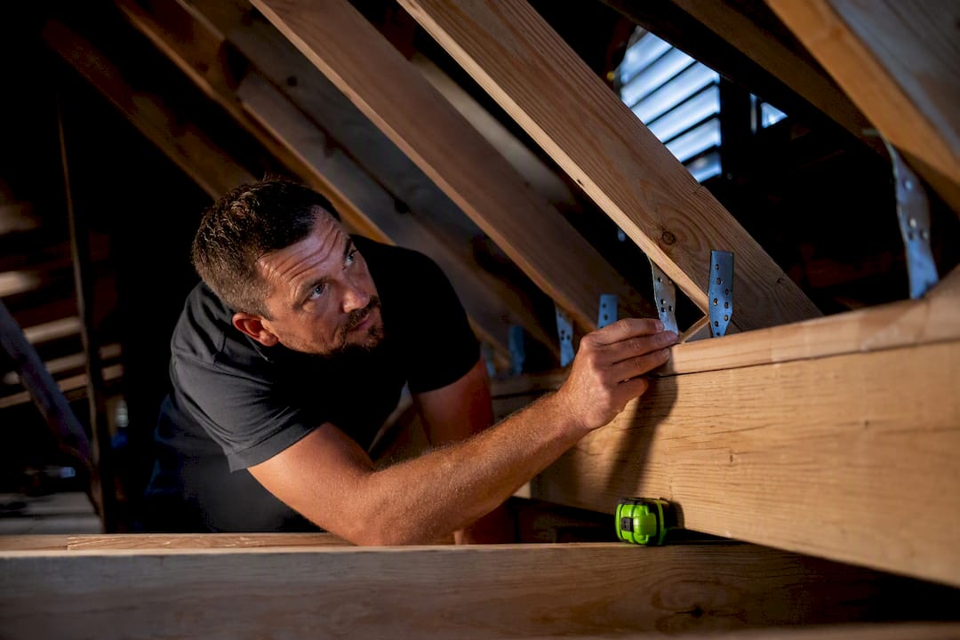Attic roof-to-wall connector prepared for inspection
