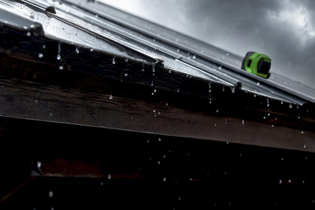 Rain striking metal roof panel edge