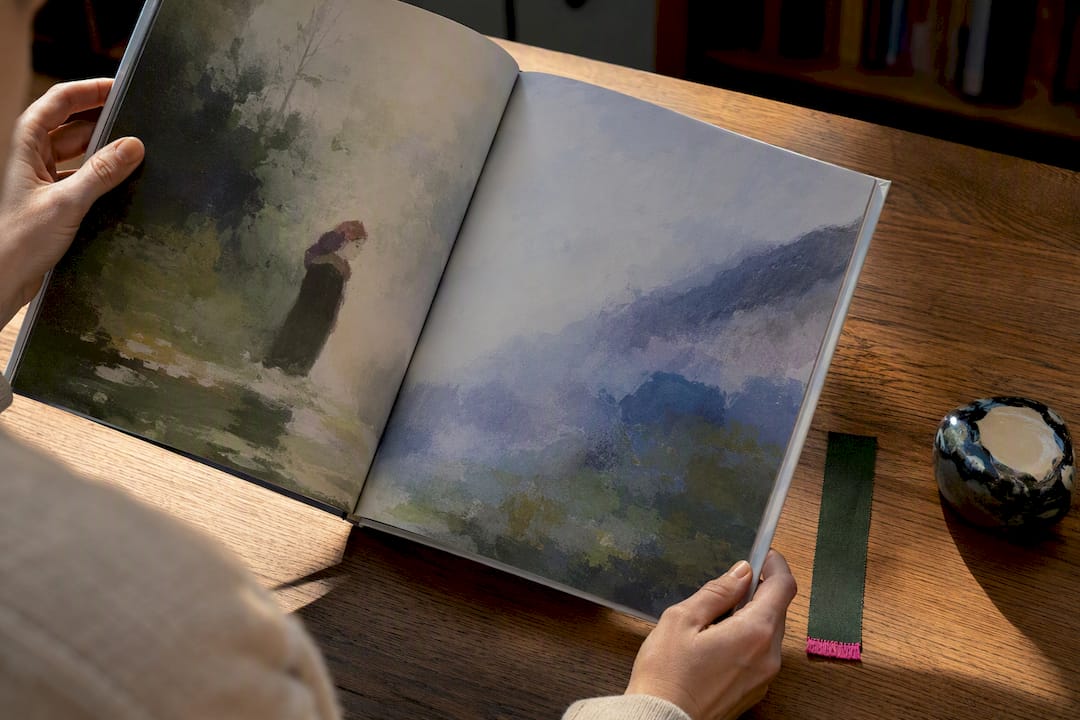 Hands reviewing final picture book pages
