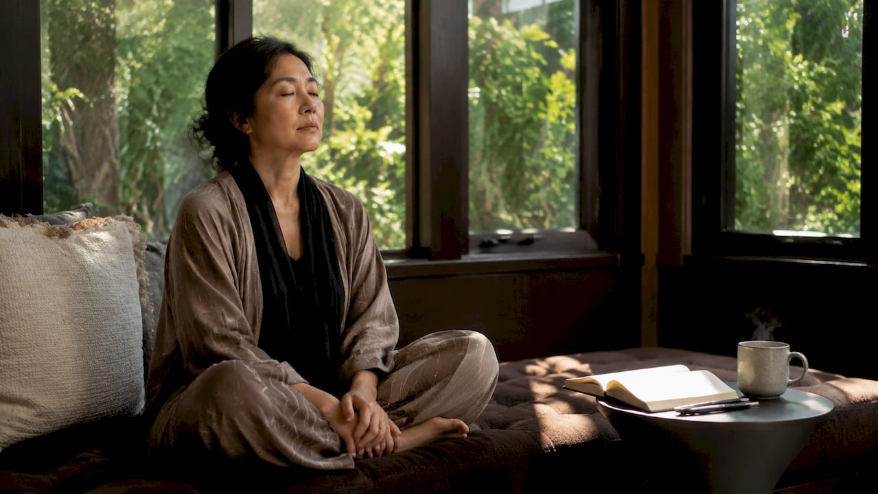 Woman reflecting quietly at home