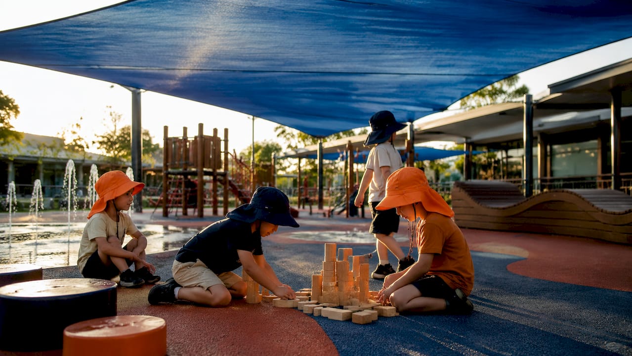 Playground with shade sails and children playing