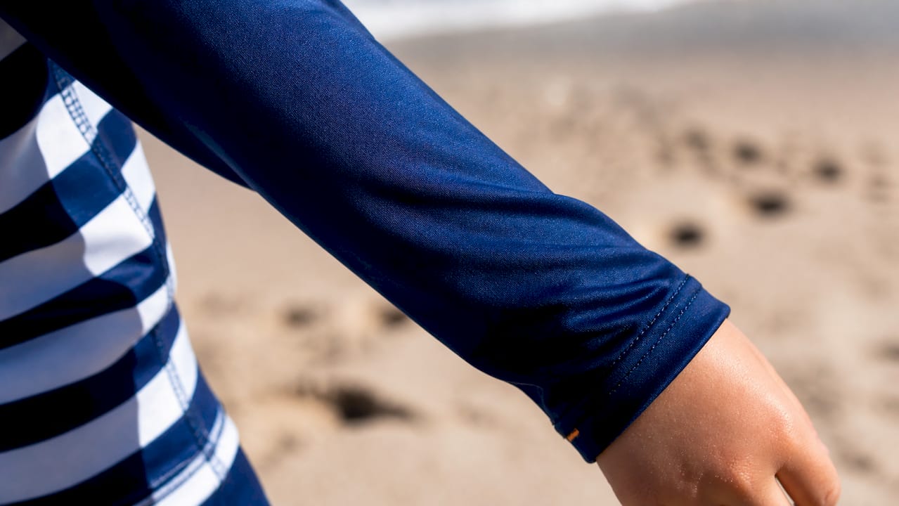 Close-up of stretched UPF fabric on child's shoulder