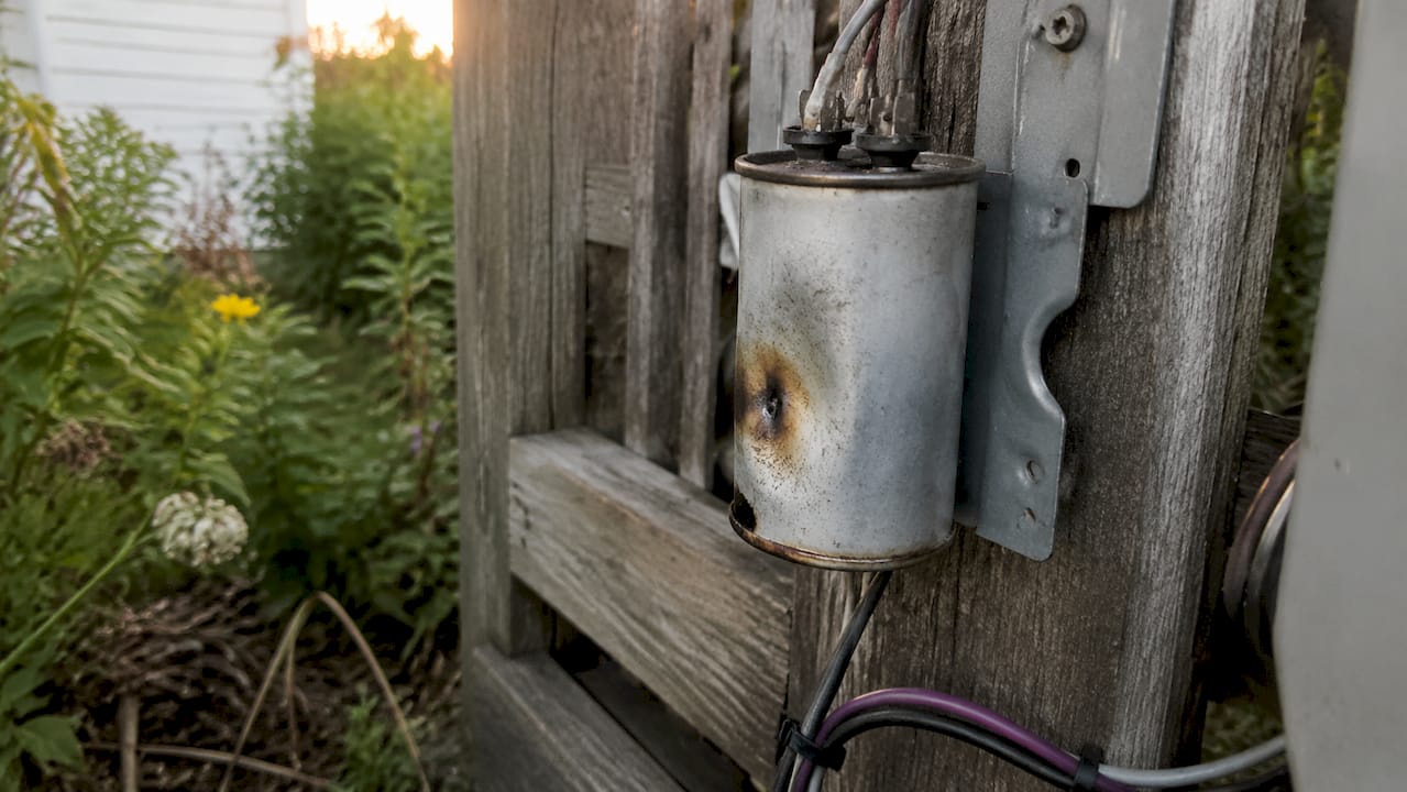 Close-up of overheated damaged HVAC capacitor