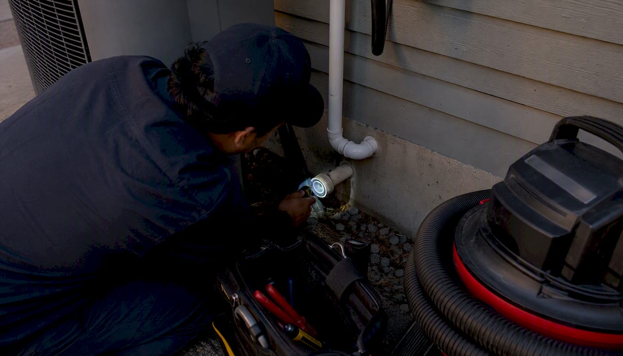 Flashlight inspection inside condensate drain pipe