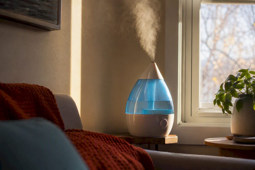 Steam humidifier dispersing steam in bedroom