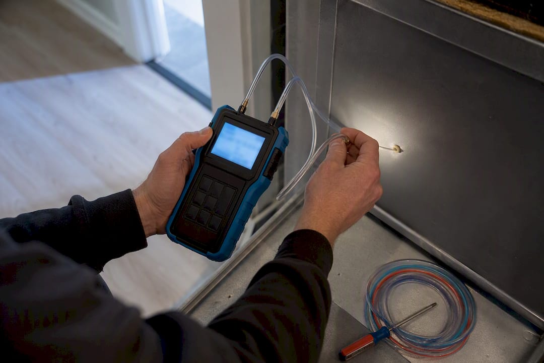 Technician measuring HVAC static pressure