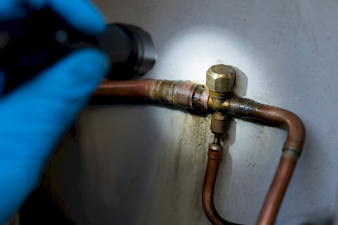 Oil residue around refrigerant line joint