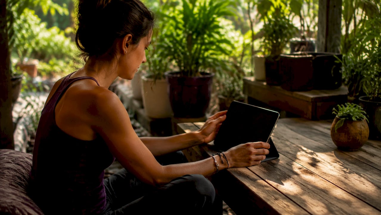Hands preparing laptop camera for virtual therapy