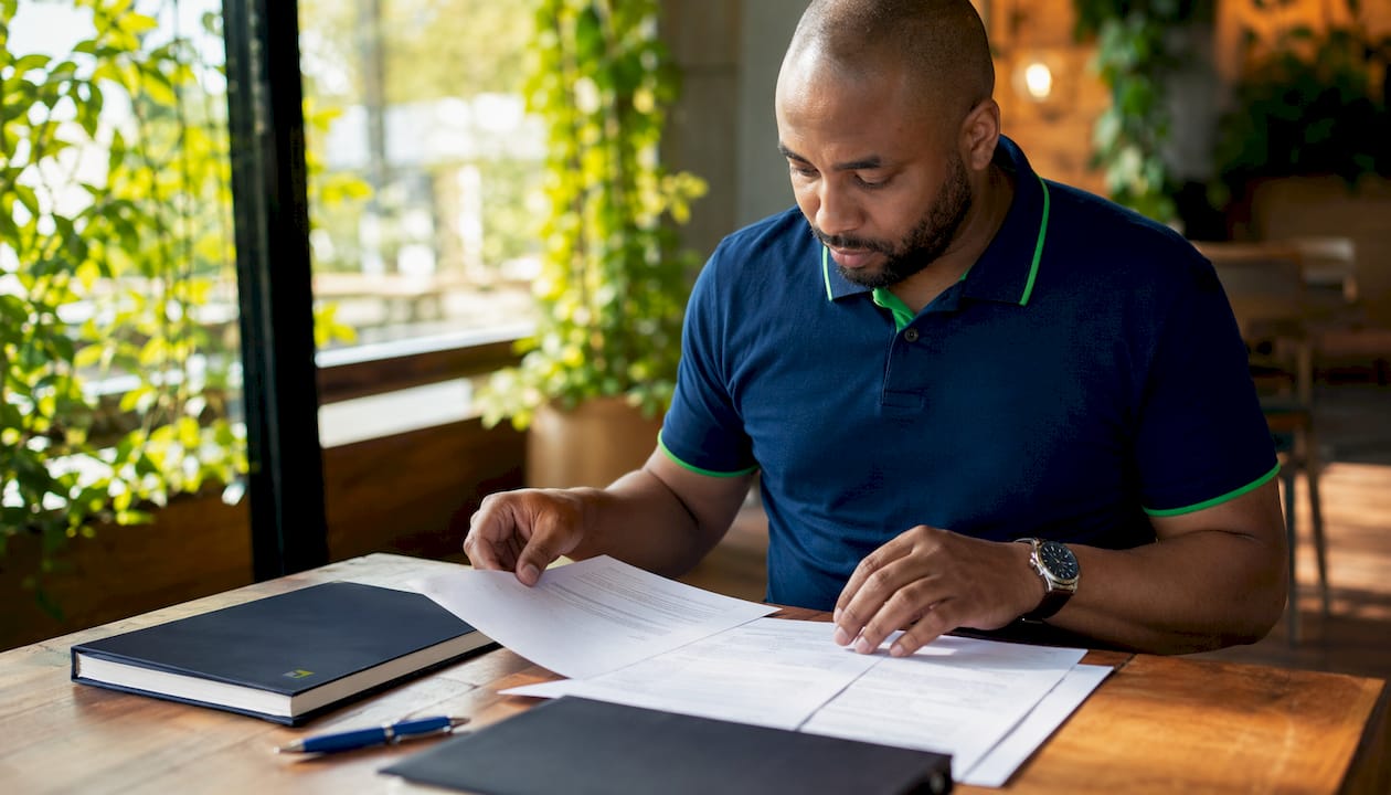 Hands organizing corporate annual minutes paperwork