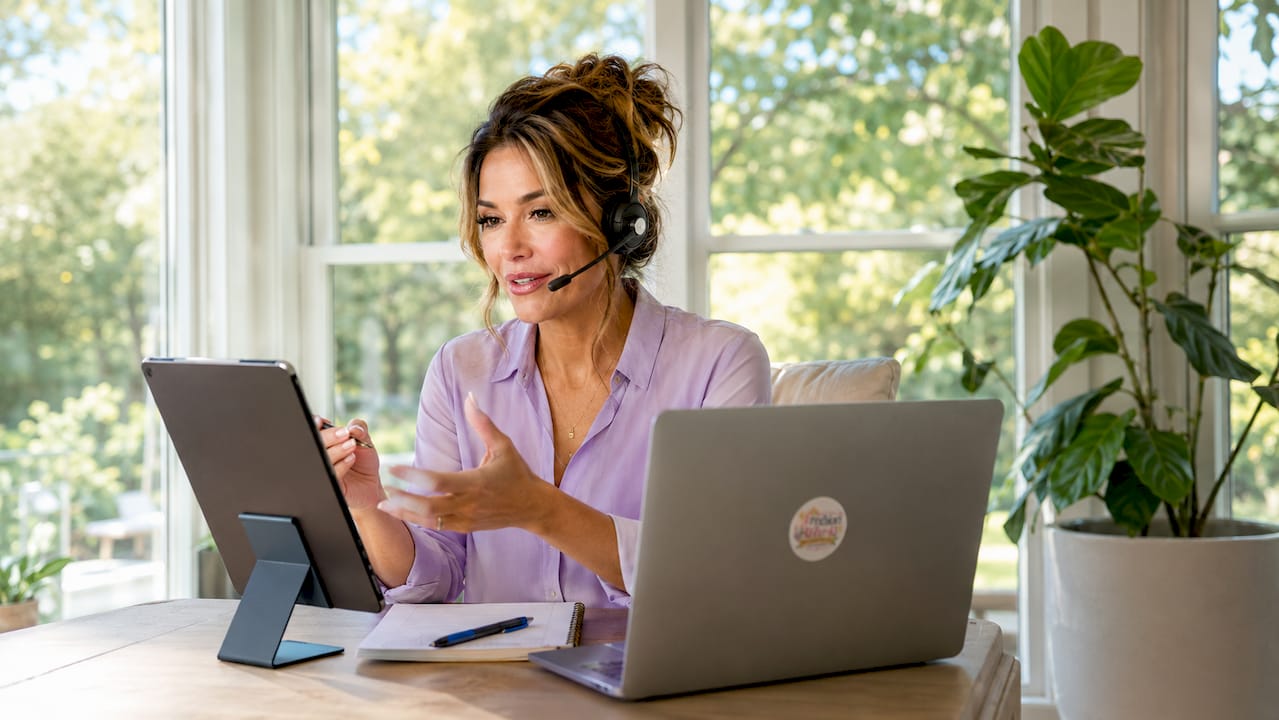 Tutor speaking with headset at home desk