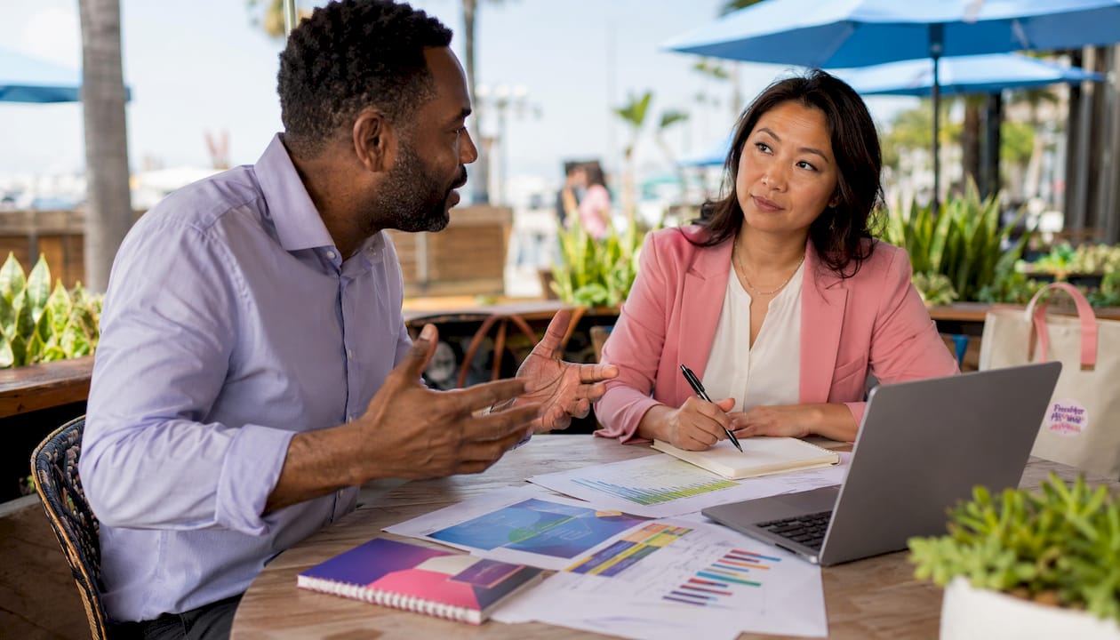 Professionals discussing REIT investments