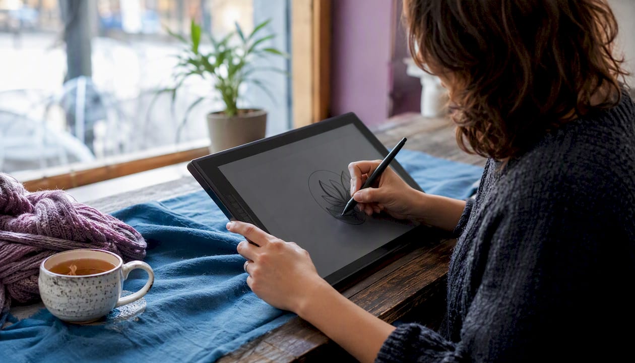 Hands drawing logo on digital tablet