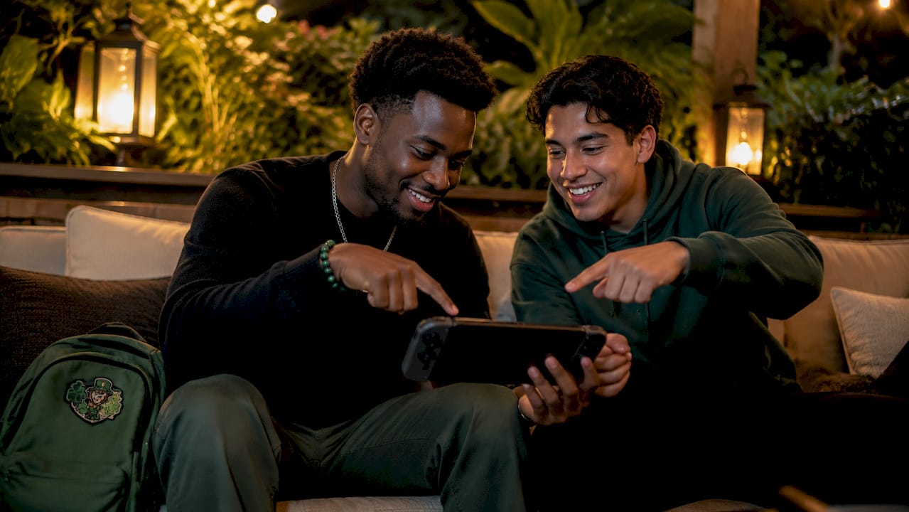 Two gamers analyzing referral dashboard on tablet