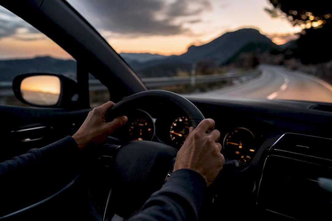 Hands steering wheel in open world driving game