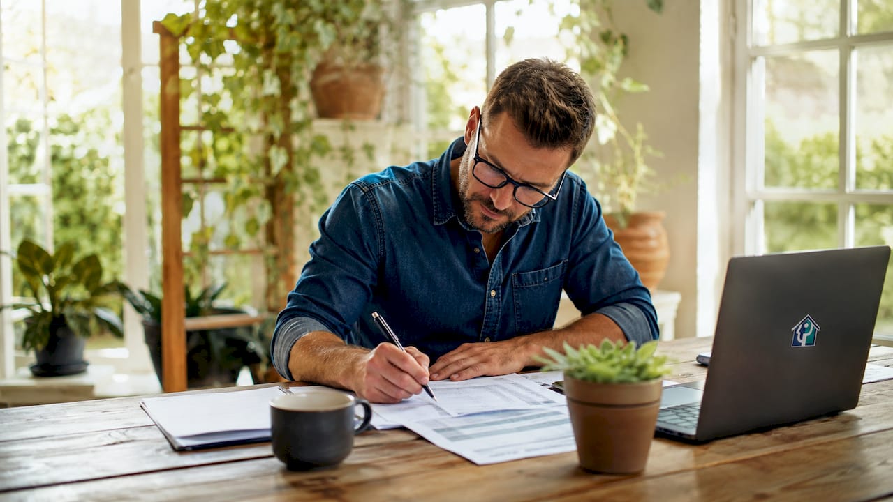 Investor calculating ARV and repair costs at kitchen table
