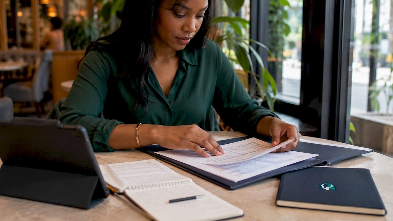 Close-up of hands calculating rental income figures