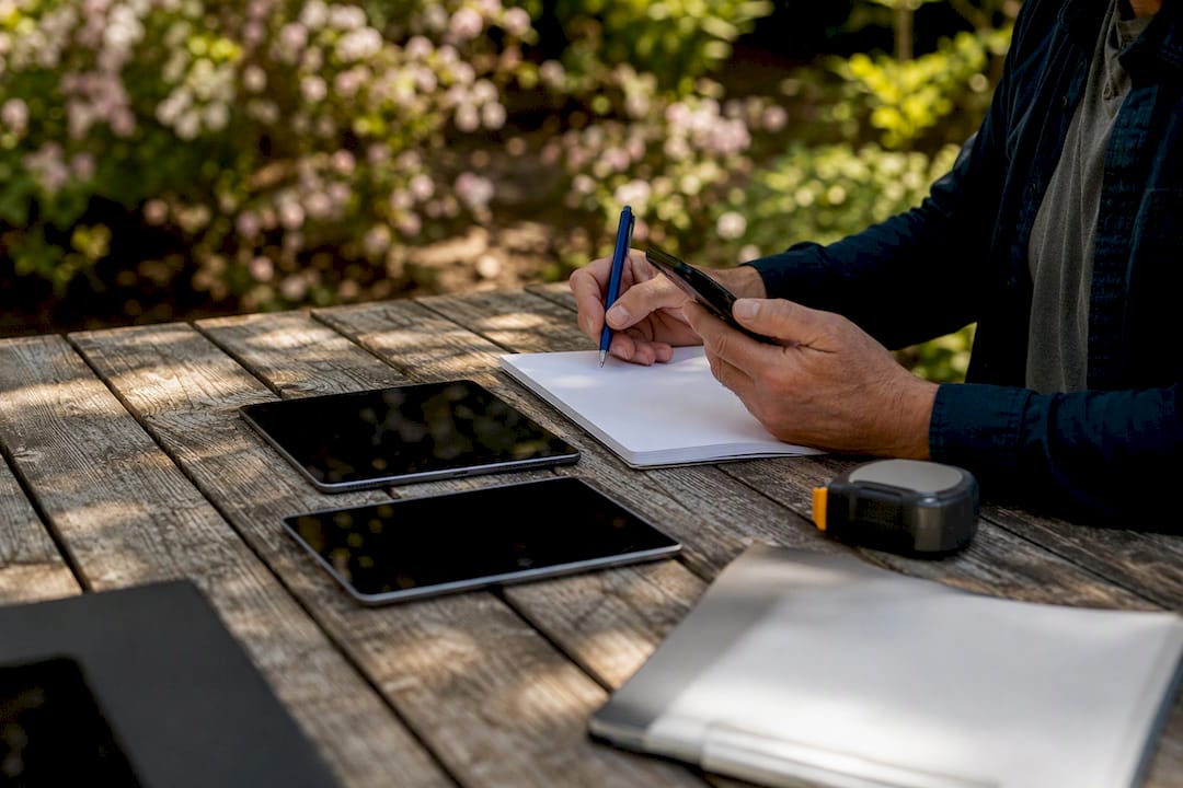 Investor manually checking real estate data outdoors