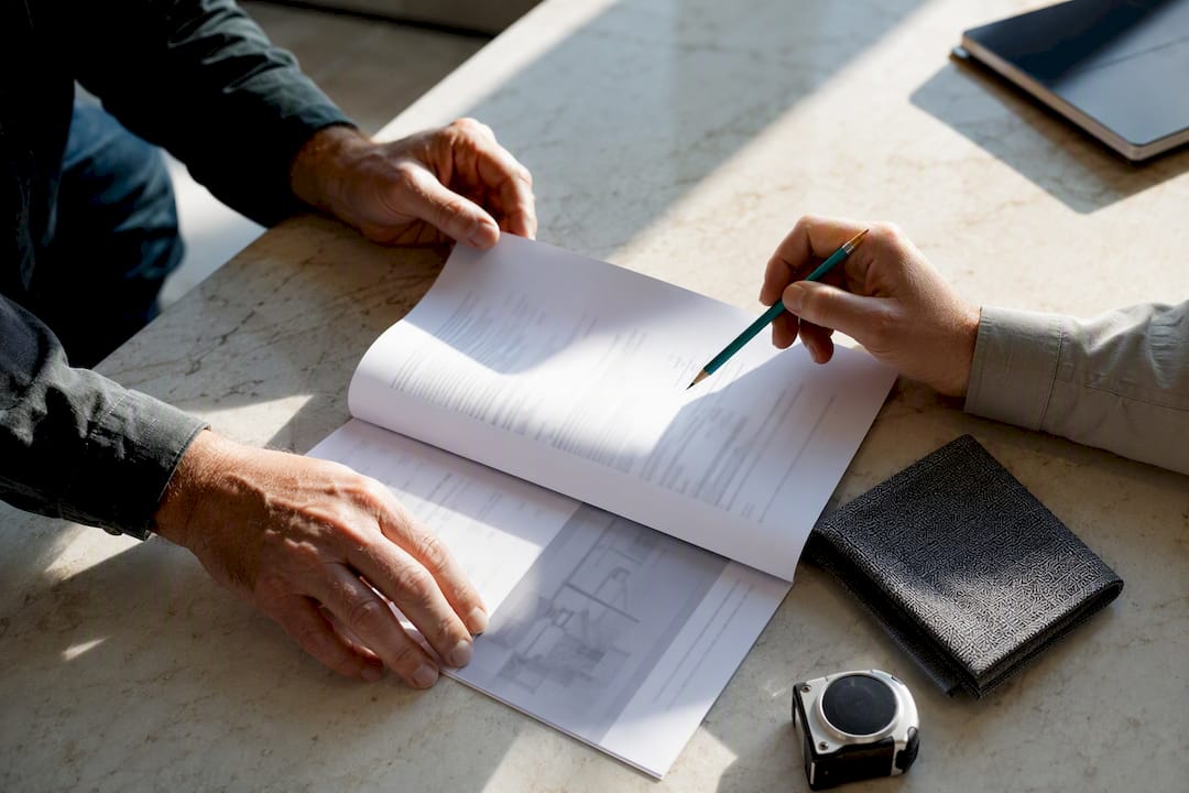 Hands reviewing a renovation scope document