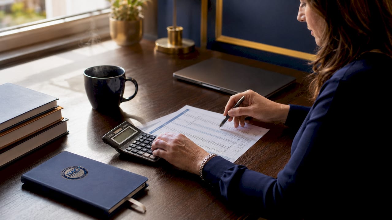 Hands calculating DSCR loan qualification details