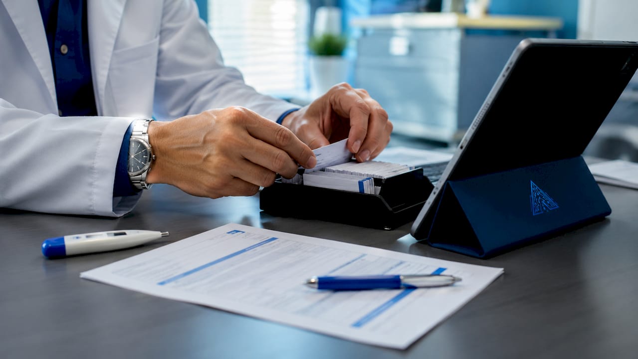 Hands managing AI tools on clinic tablet