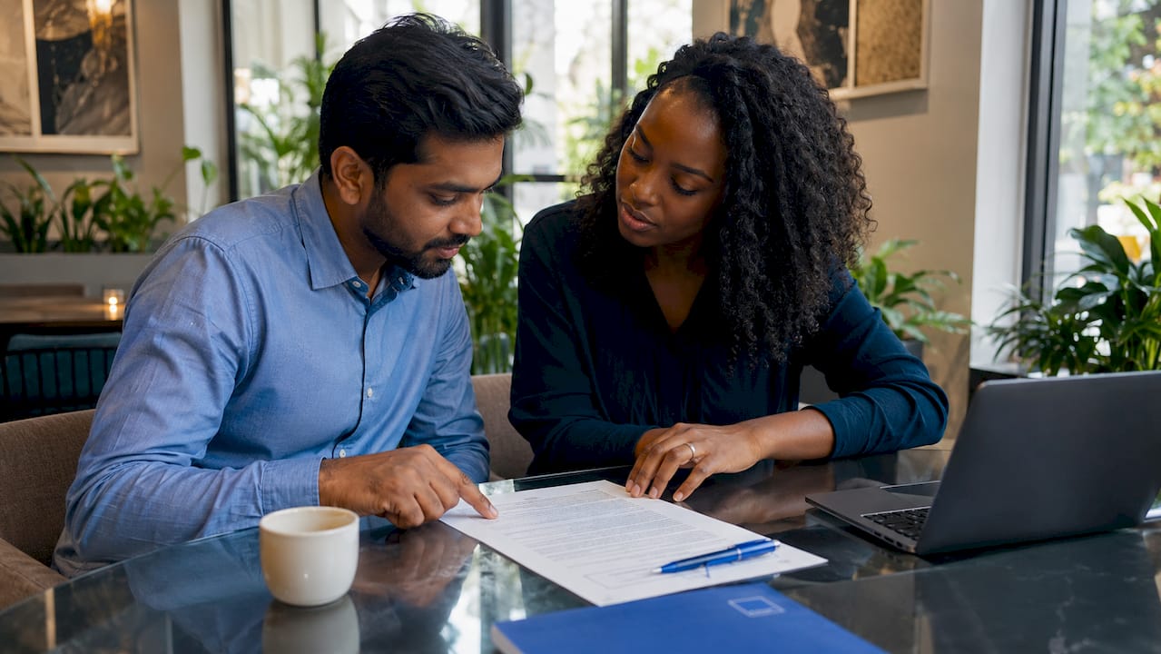 Two professionals pointing at Payment Services Act document