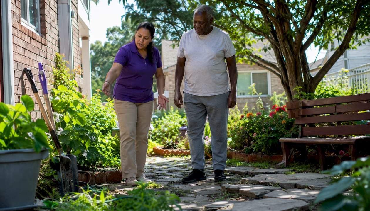 Caregiver assessing home safety with senior