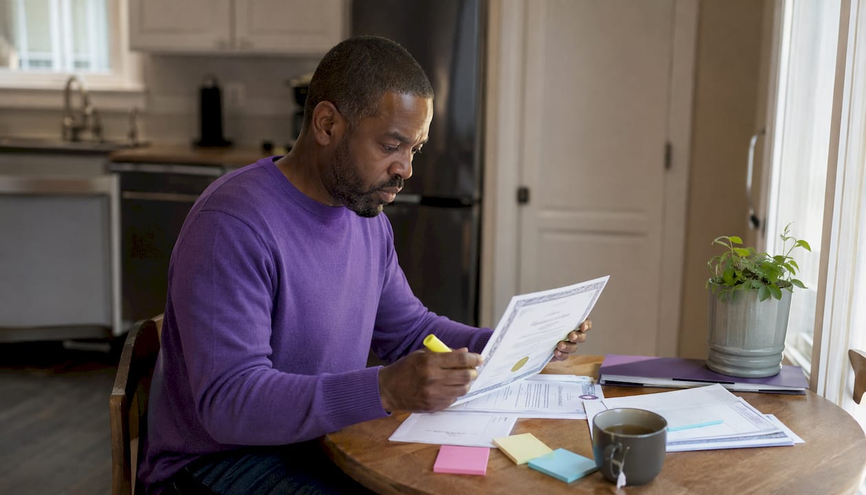Hands examining home care agency license