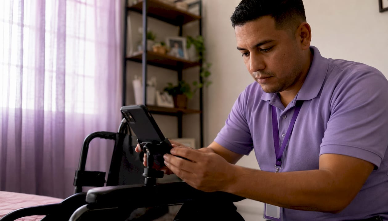 Caregiver clocking time on smartphone outdoors