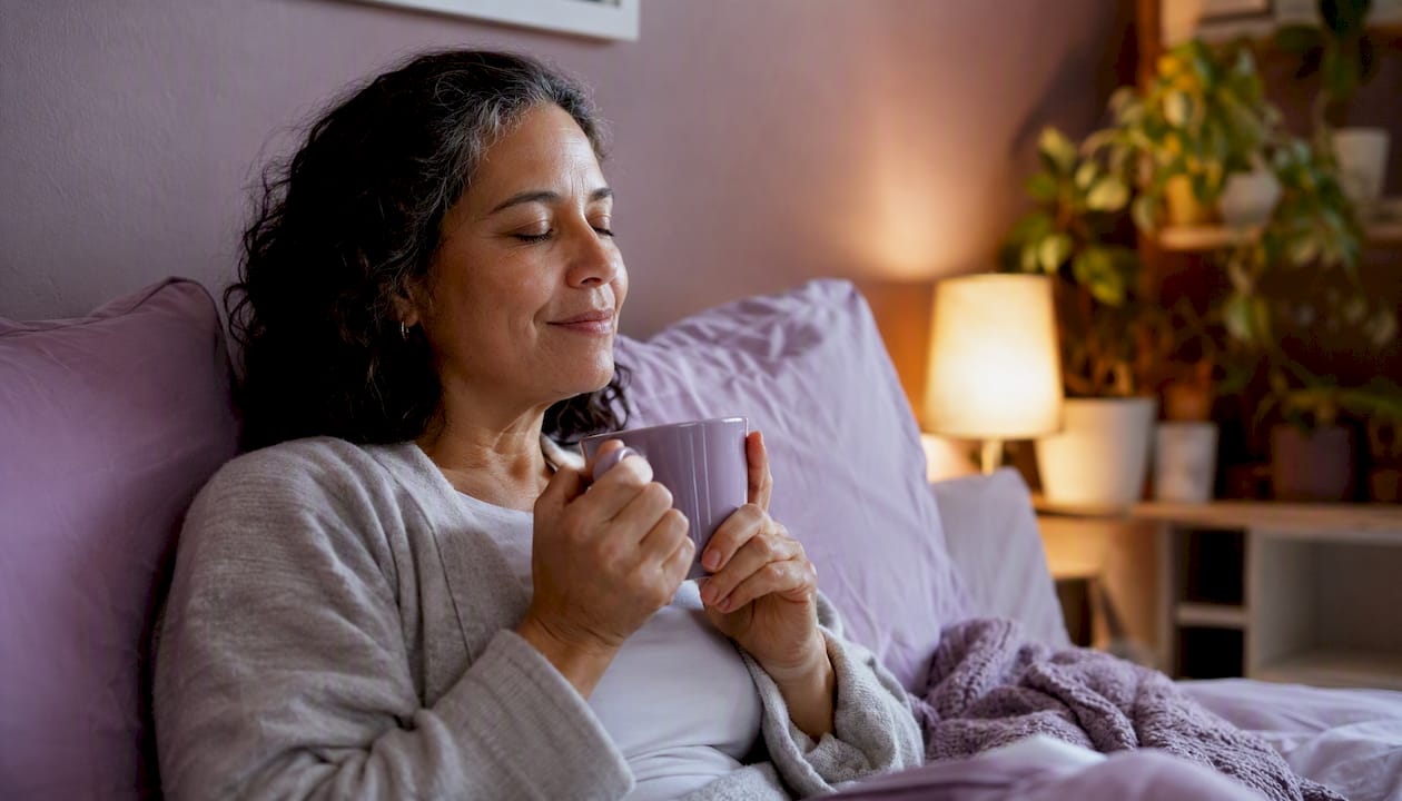 Caregiver resting on sofa with mug