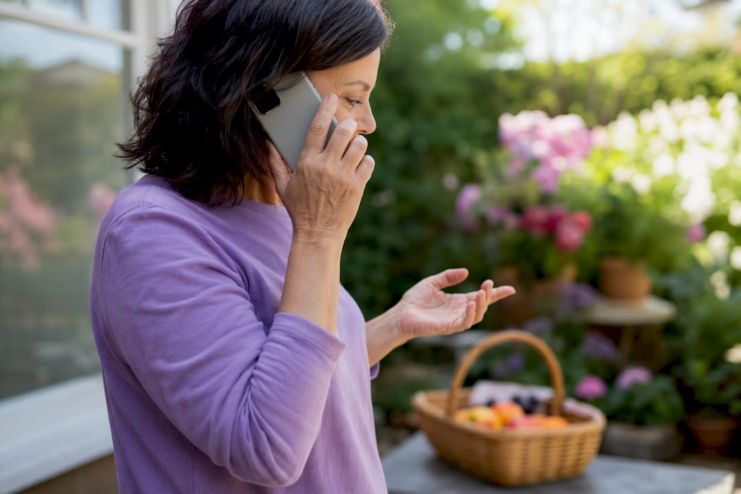 Caregiver hands holding phone delegating task