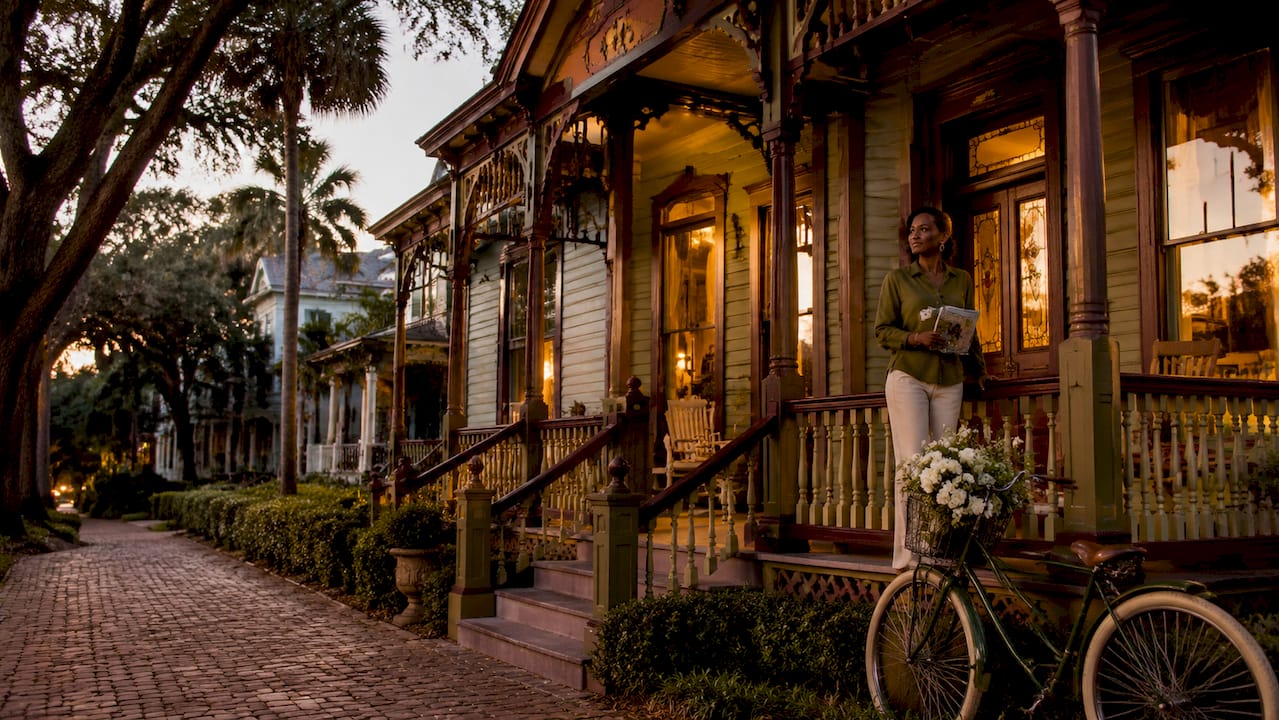 Historic Victorian home exterior with visitor