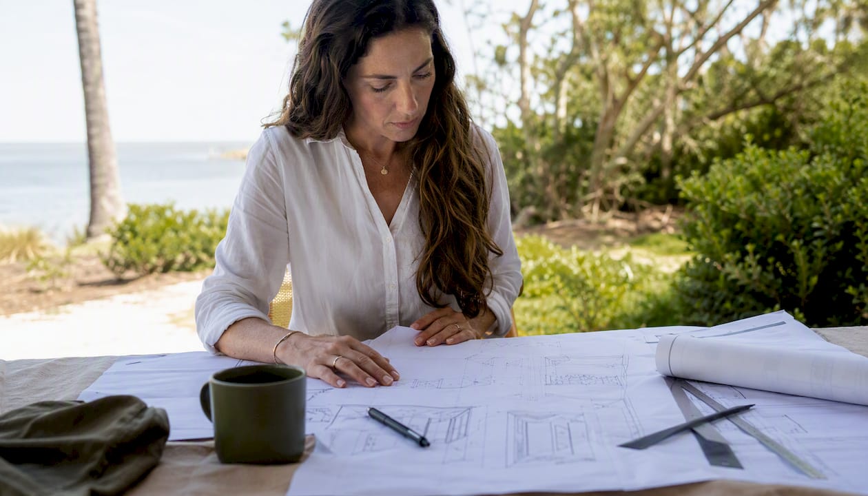Architect reviewing Lowcountry home plans outdoors