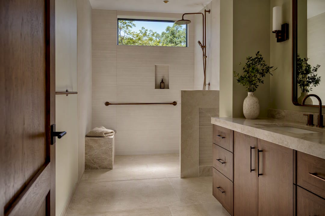 Curbless shower with accessible bathroom circulation