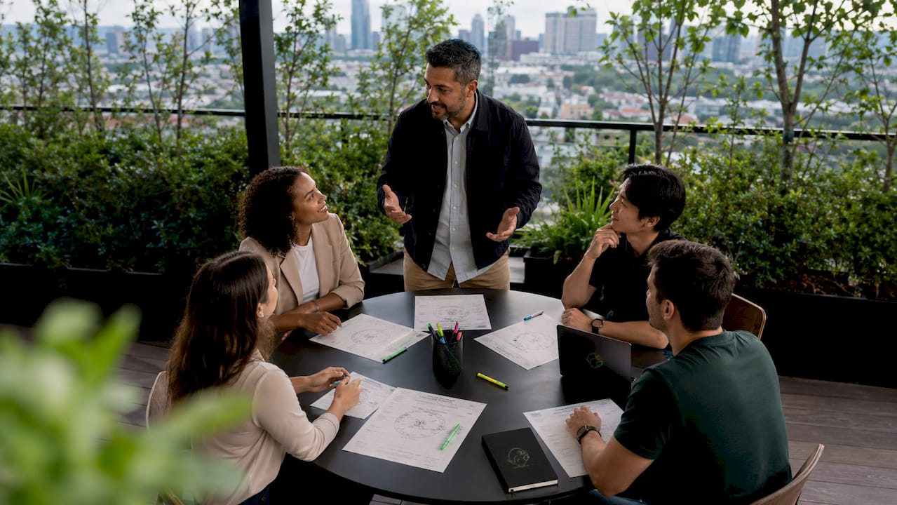 Team discussing 360-degree feedback in meeting room
