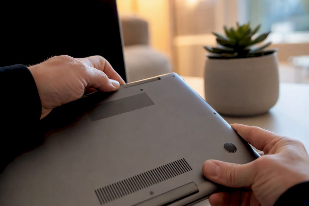 Hands inspecting serial number on device