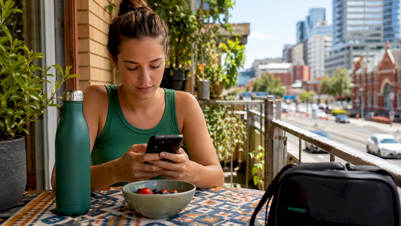 Australian woman using budget shopping apps at home