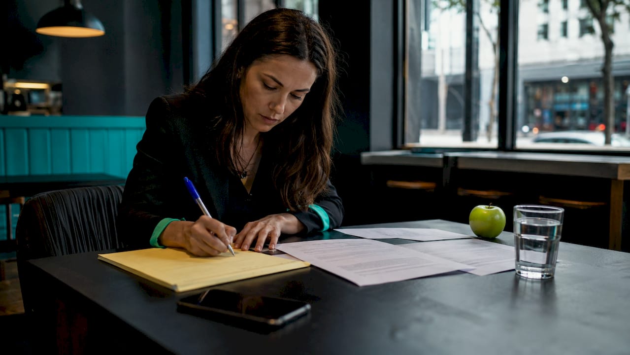 Woman taking notes on incident response clauses