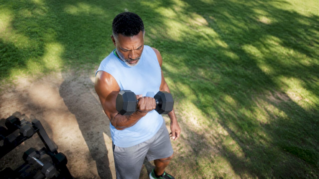 Man lifting weights in home gym