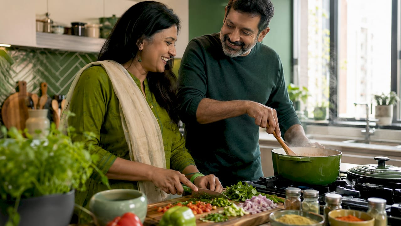 Couple cooking new recipe together in kitchen