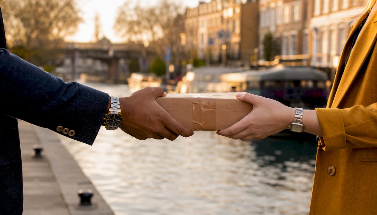 Parcel handover on London street corner
