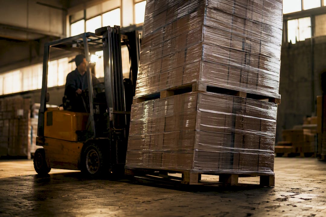 Forklift pushing a high pallet stack
