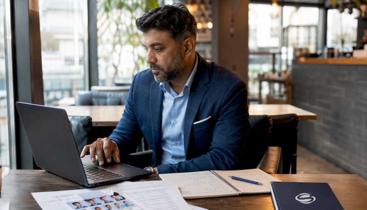 Professional working with mortgage CRM at desk