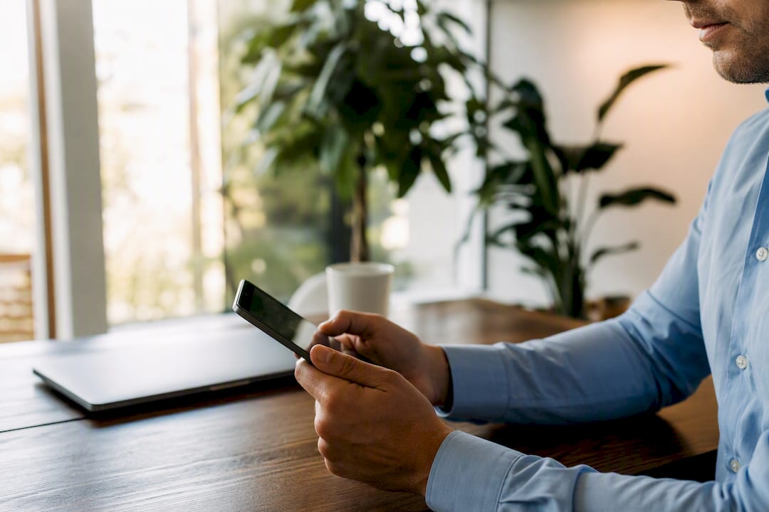 Hands holding device edge symbolizing eNote control