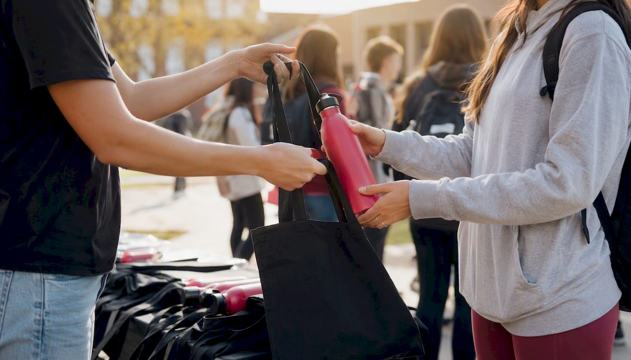 Hands distributing orientation merchandise
