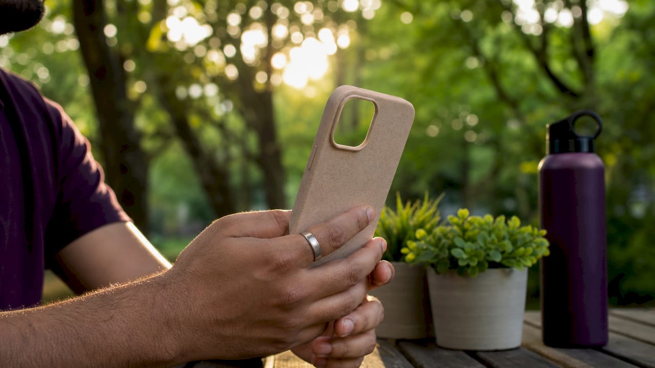 Hands holding plant-based biodegradable phone case