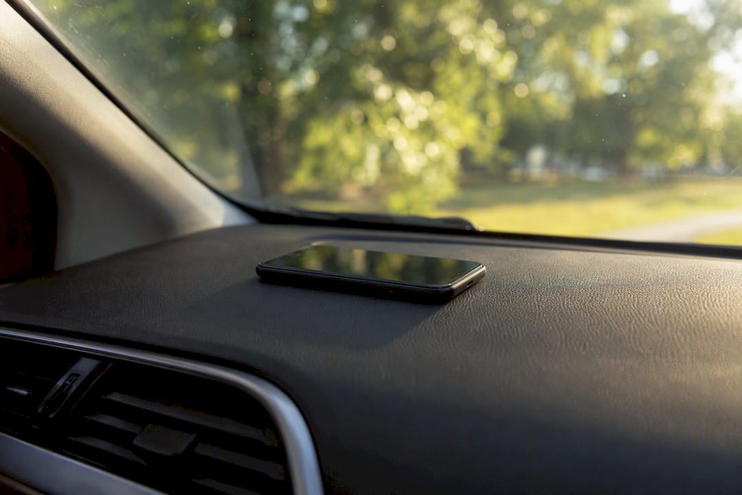 Smartphone on car dashboard exposed to sunlight