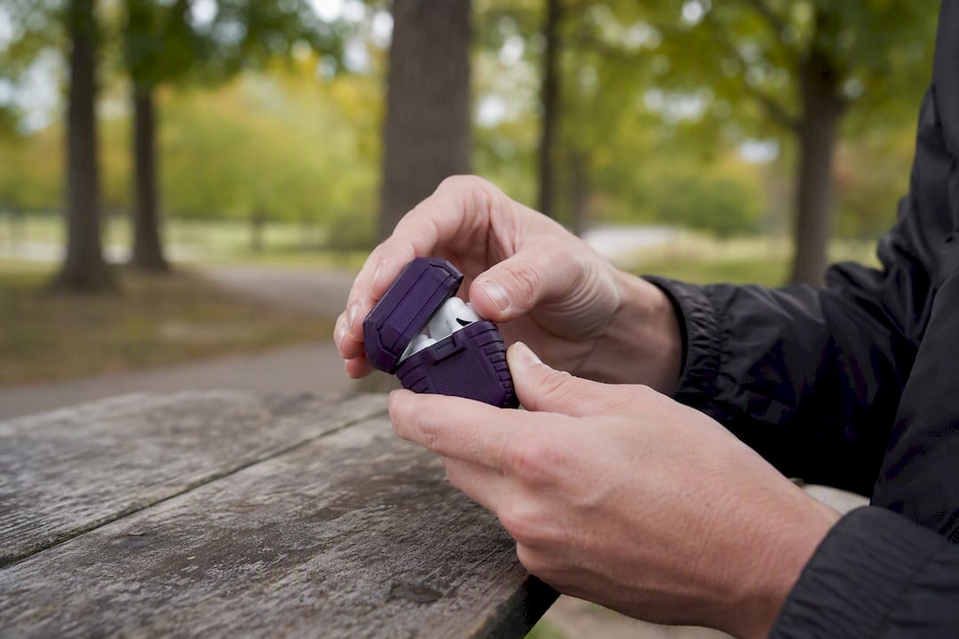 Hands snapping rugged AirPods case lid shut