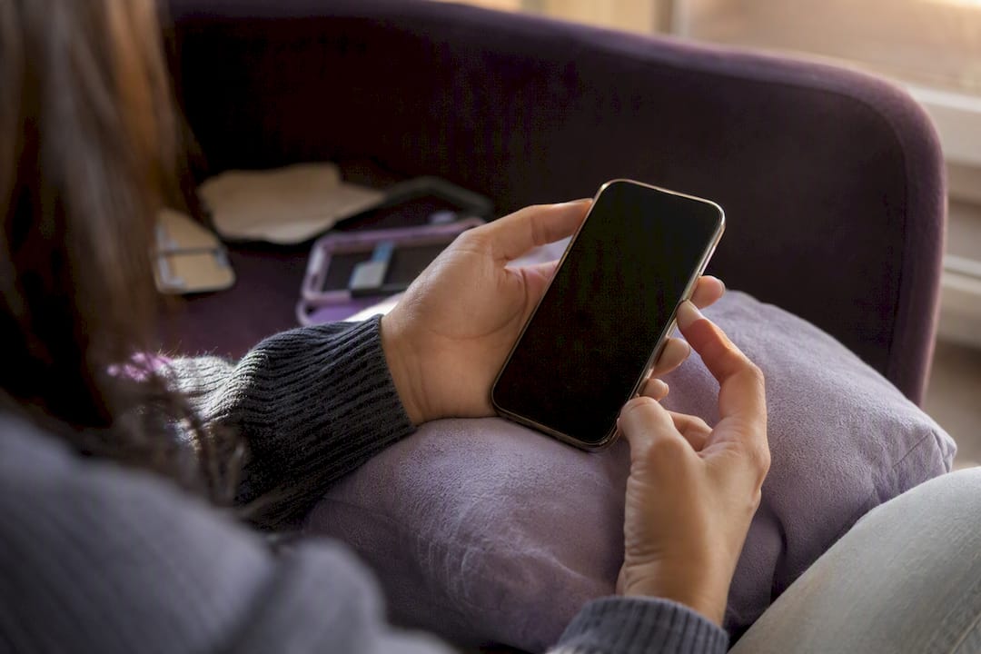 Hands submitting phone case request via smartphone