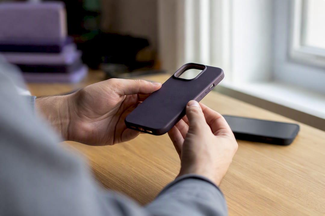 Hands inspecting cut-outs on custom phone case