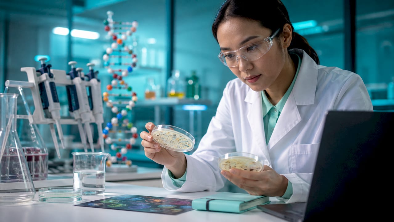 Scientist in lab reviewing enzyme samples